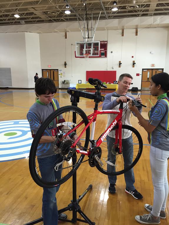 Roger Jeffs helping Center for Creative Studies students build a bike for their cycling team